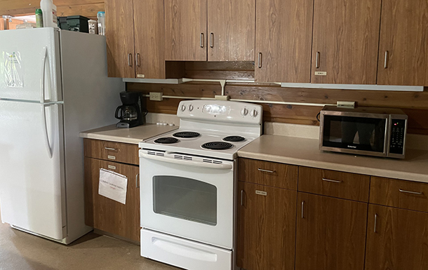 close up of the kitchen featuring a fridge, oven, and microwave