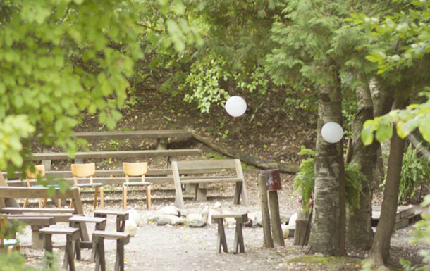 the firebowl area at camp decorated for a wedding ceremony