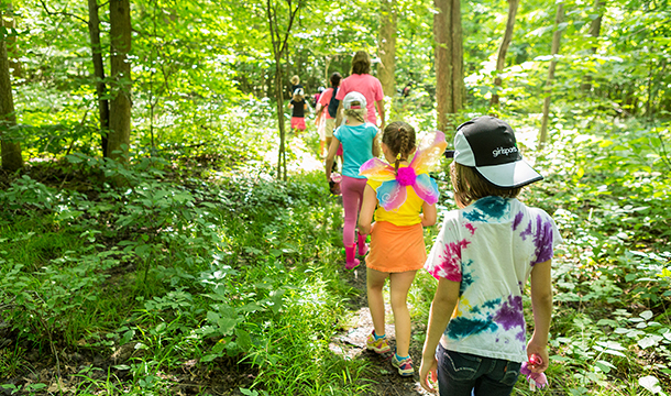 group of girls hiking in a forest