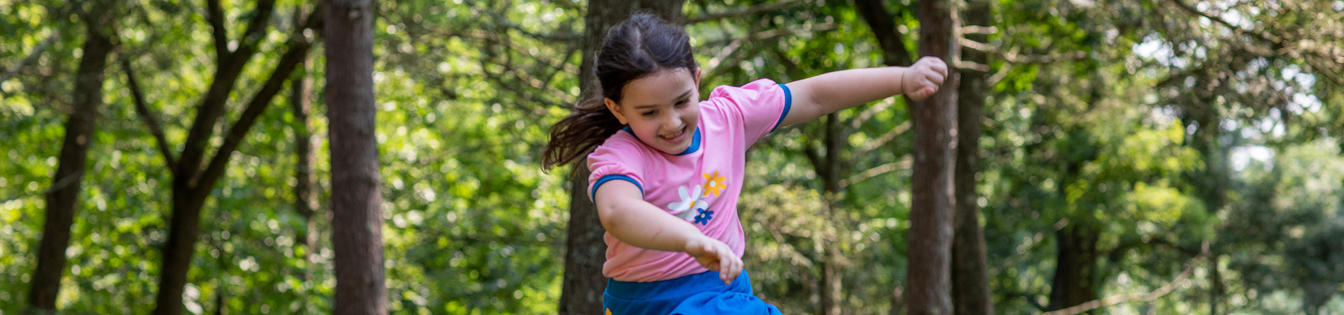  girl scout daisy joyfully running through a field 