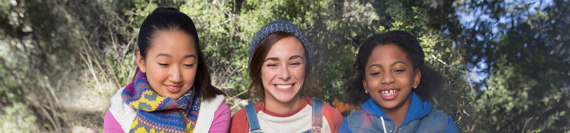  three girl scouts roasting marshmallows over a campfire 