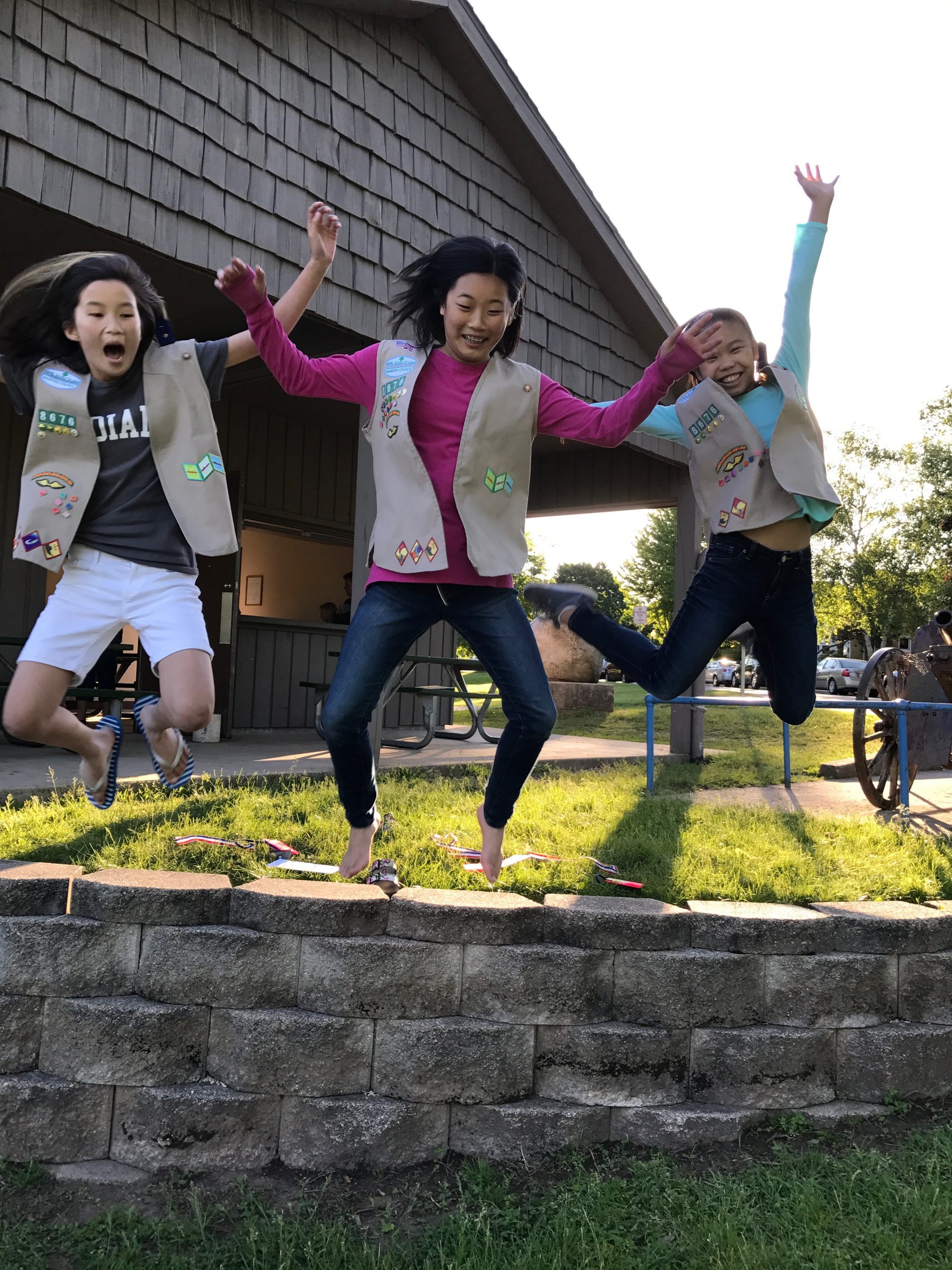 Three girls jumping off a ledge