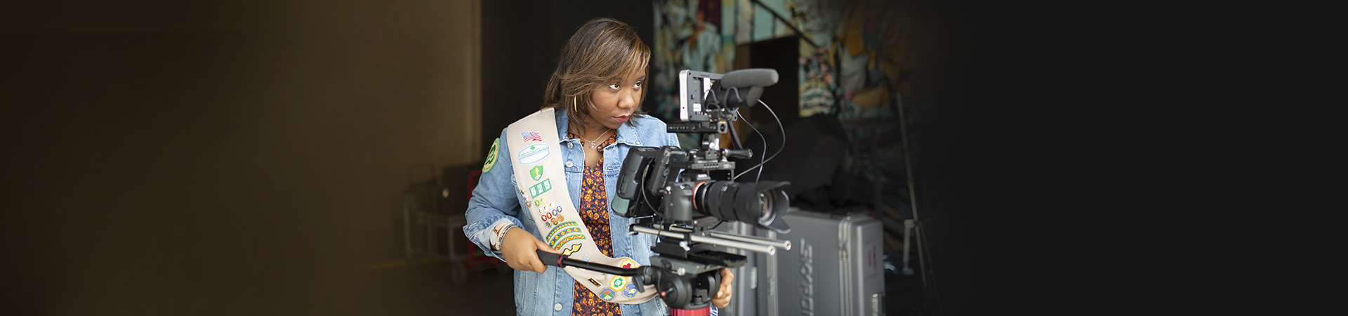  teenage girl scout focused on using a video camera 